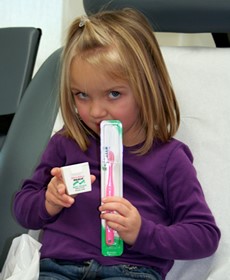 Patient with toothbursh, floss